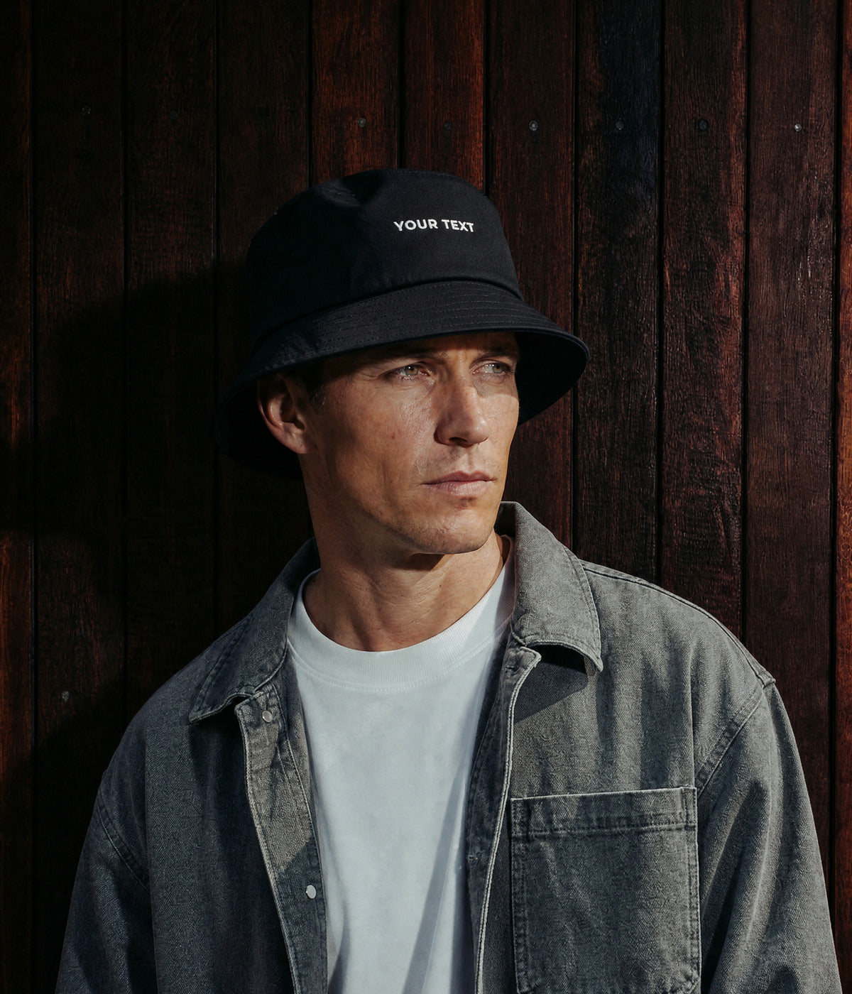 CUSTOM BUCKET HAT. BLACK worn by a man