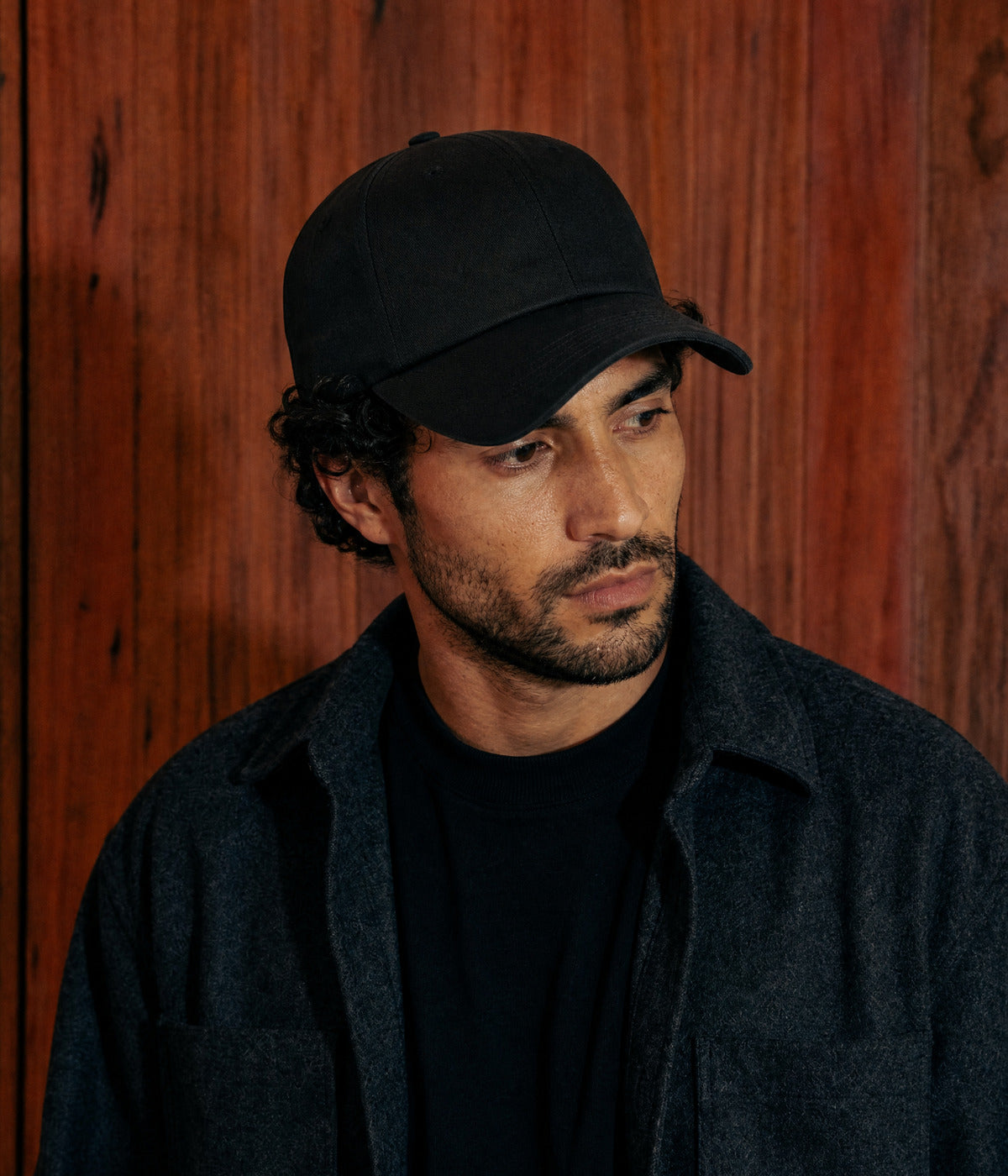 PREMIUM DAD CAP. BLACK worn by a man