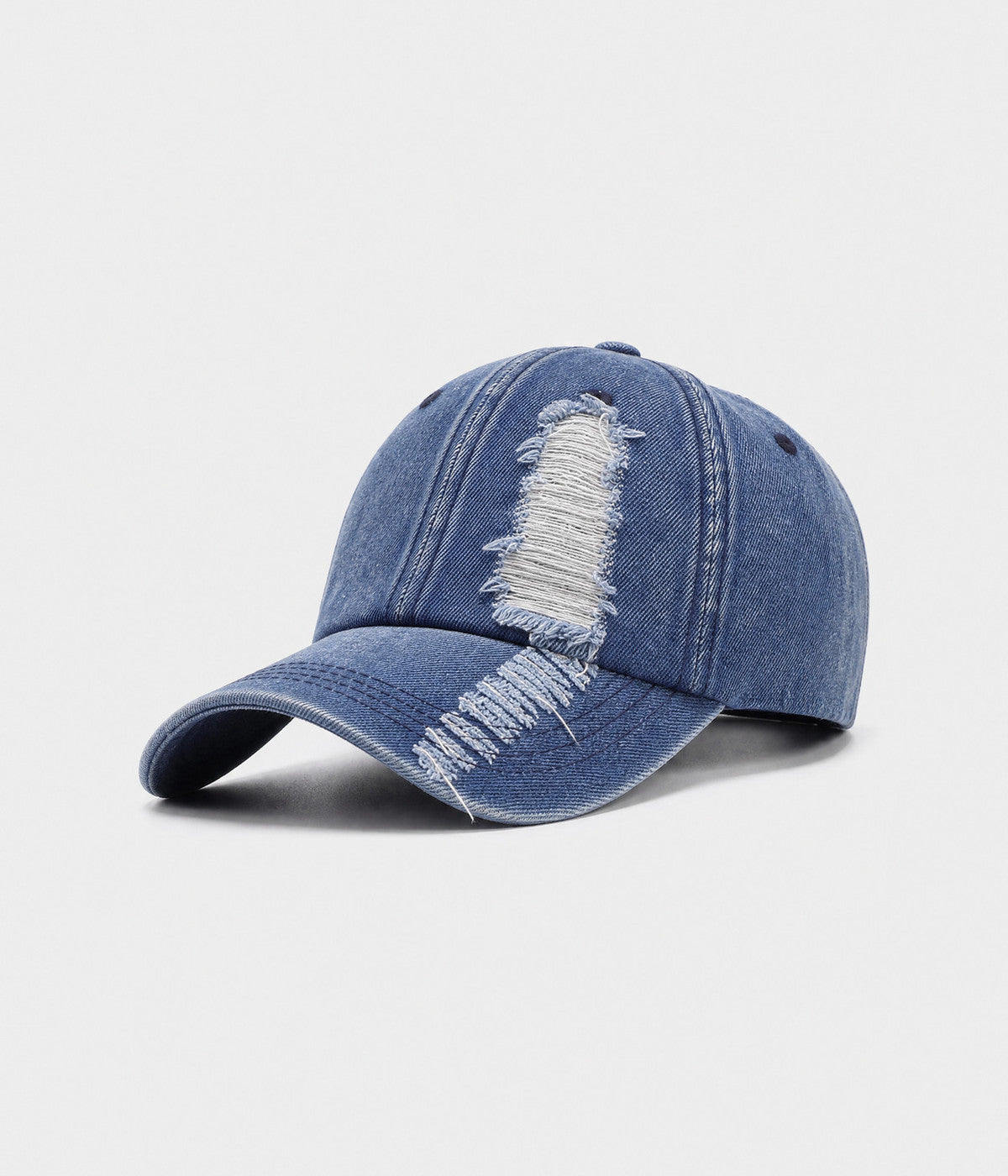 TORN DENIM. washed cotton denim cap in blue, side view