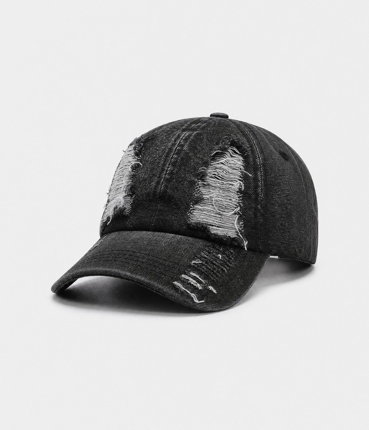TORN DENIM. washed cotton denim cap in black, side view