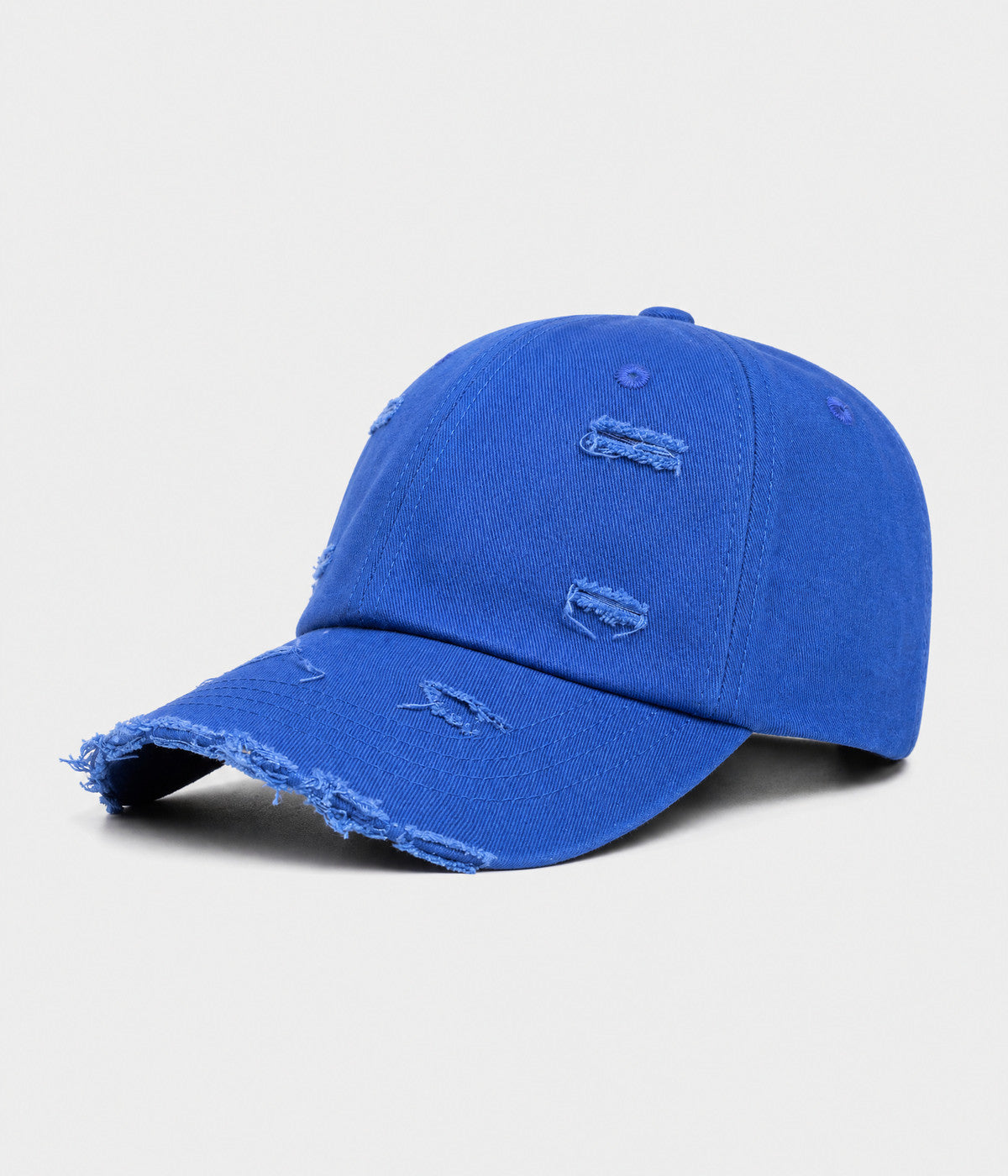 RIPPED COTTON. distressed cotton cap in blue, side view