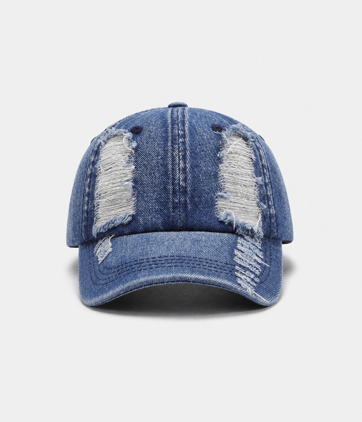 TORN DENIM. washed cotton denim cap in blue, front view