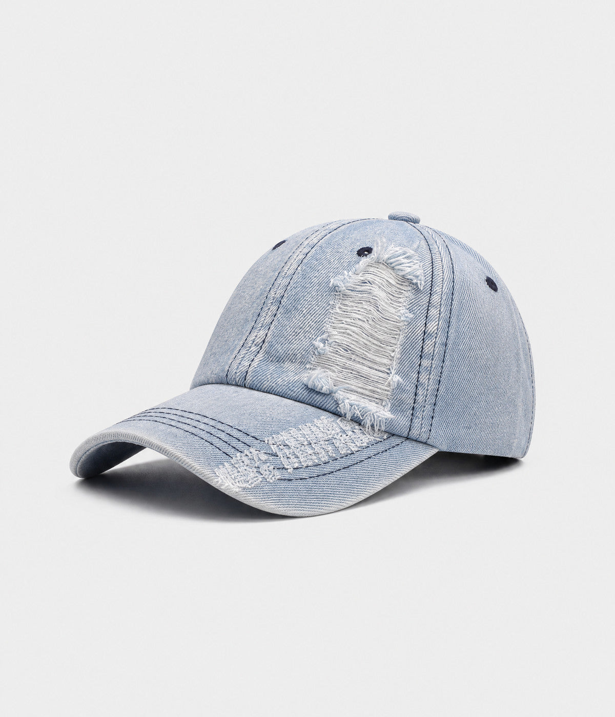 TORN DENIM. washed cotton denim cap in light blue, side view