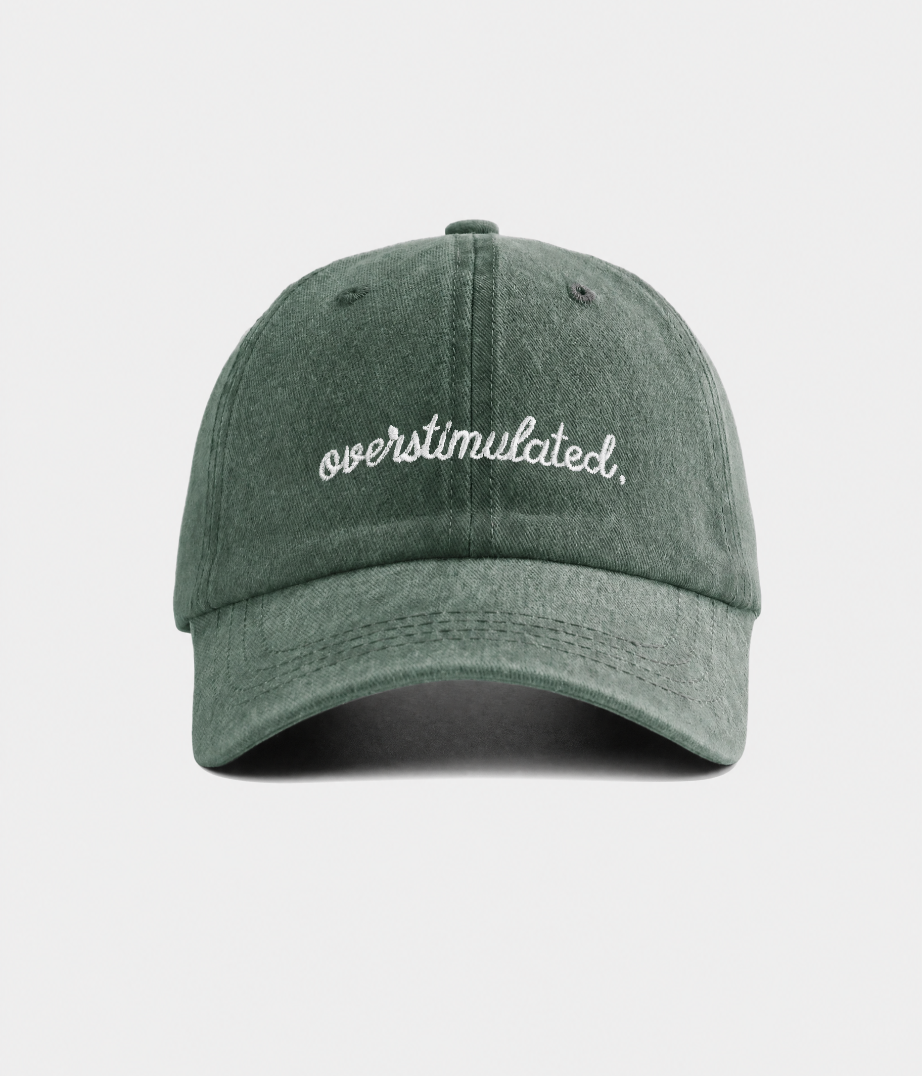 OVERSTIMULATED. washed cotton dad cap in green, front view