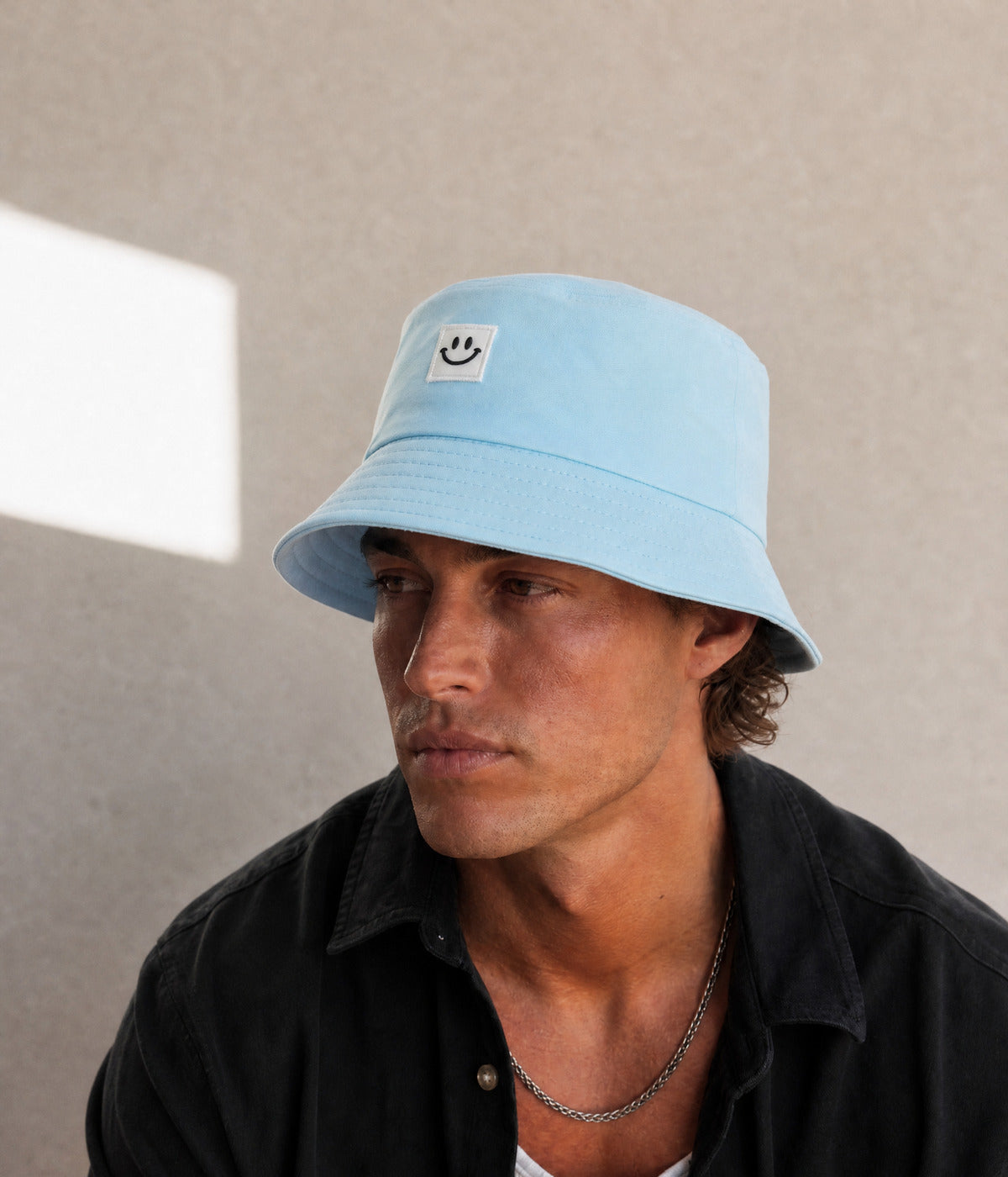 HAPPY BUCKET. BLUE worn by a man