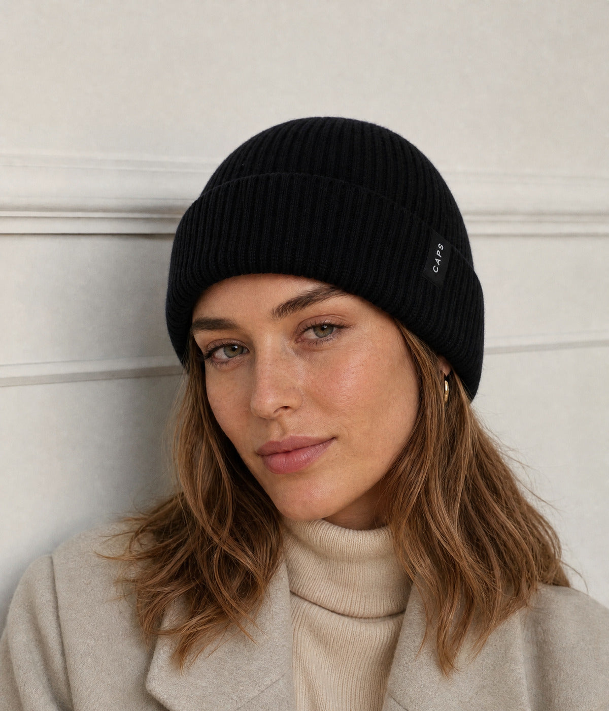 LOGO MERINO BEANIE. — BLACK worn