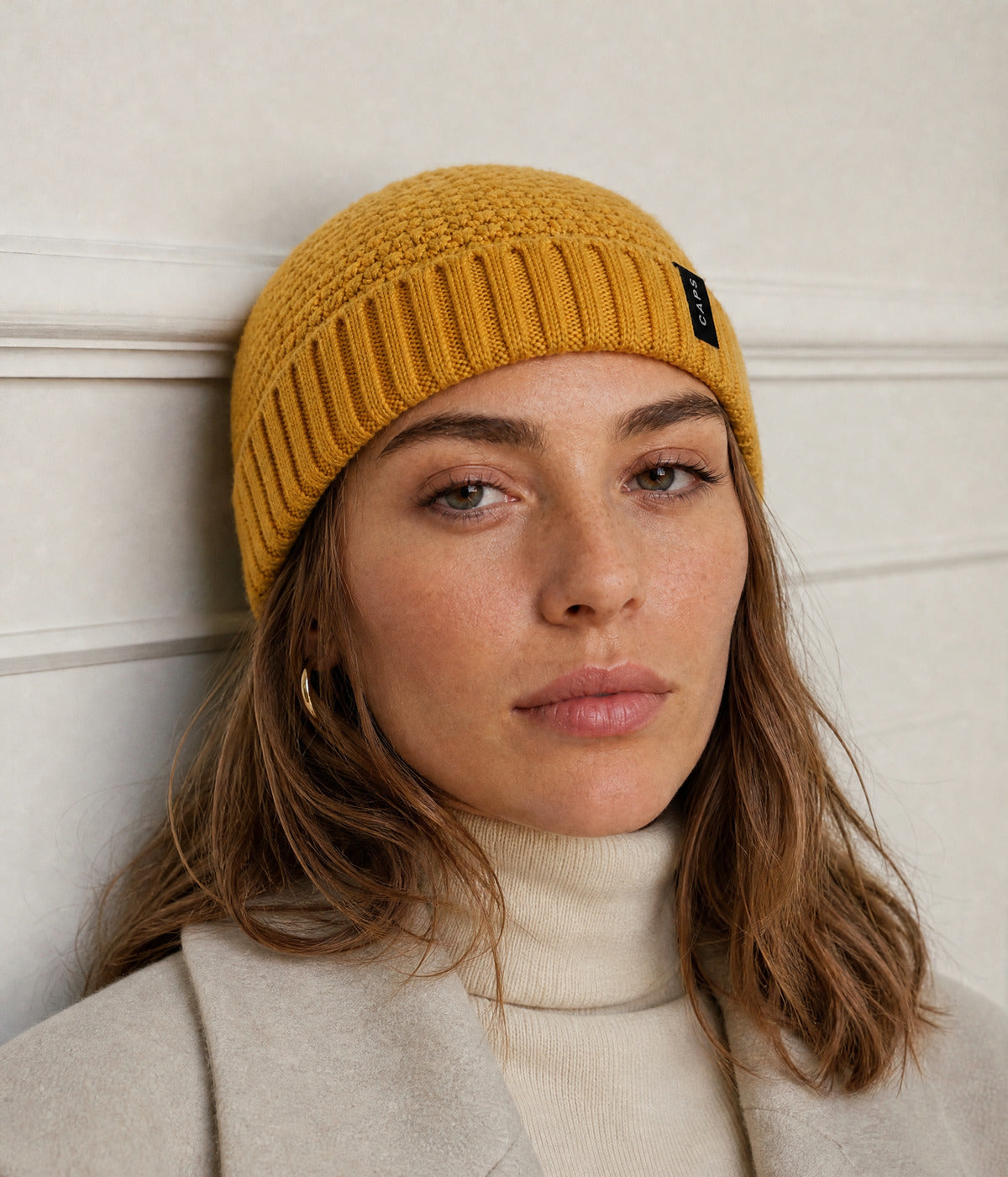 LOGO RIBBED FISHERMAN BEANIE. — MUSTARD YELLOW worn