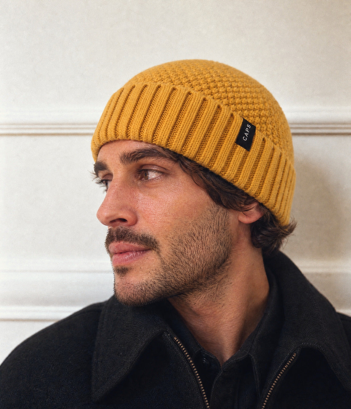 LOGO RIBBED FISHERMAN BEANIE. — MUSTARD YELLOW worn