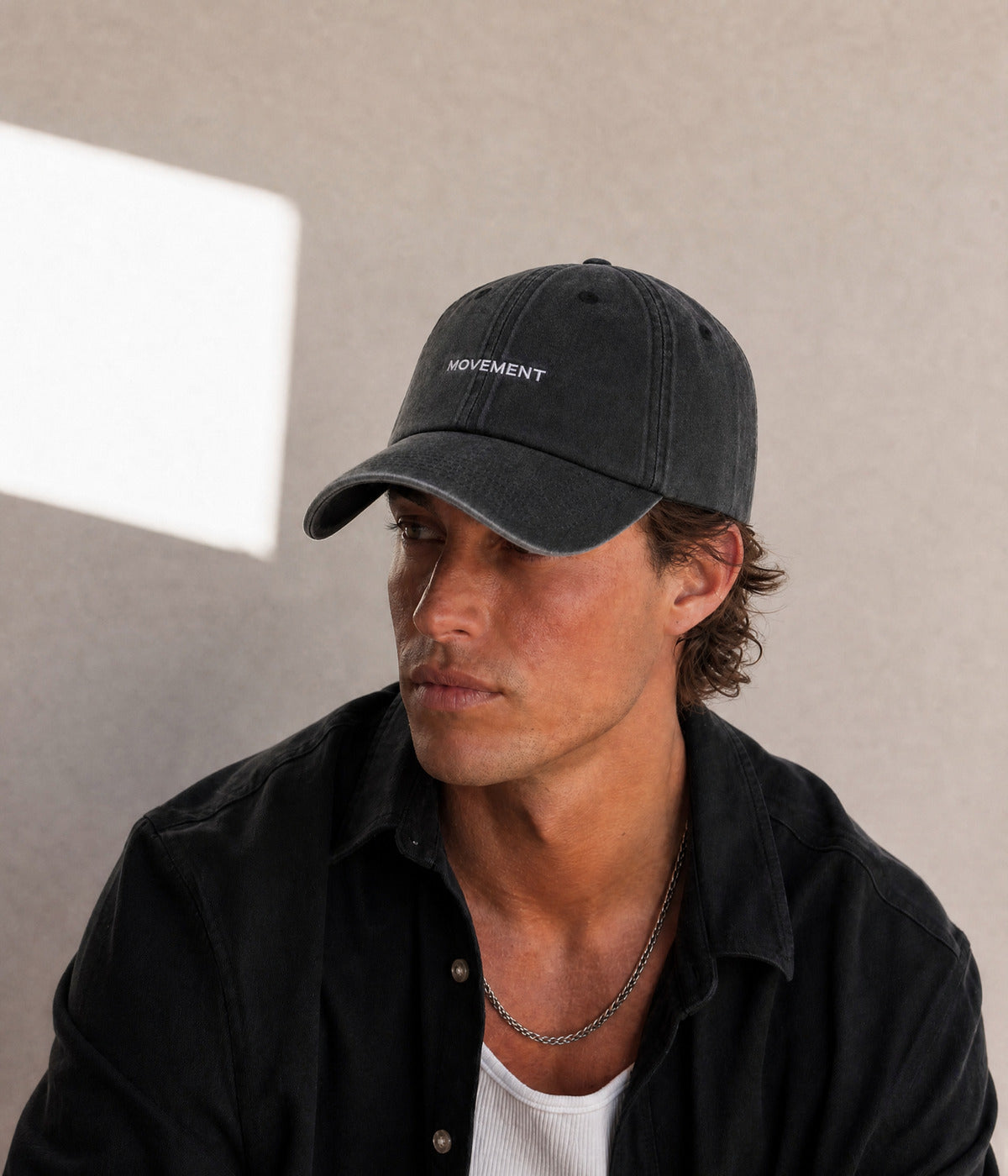 MOVEMENT. BLACK worn by a man