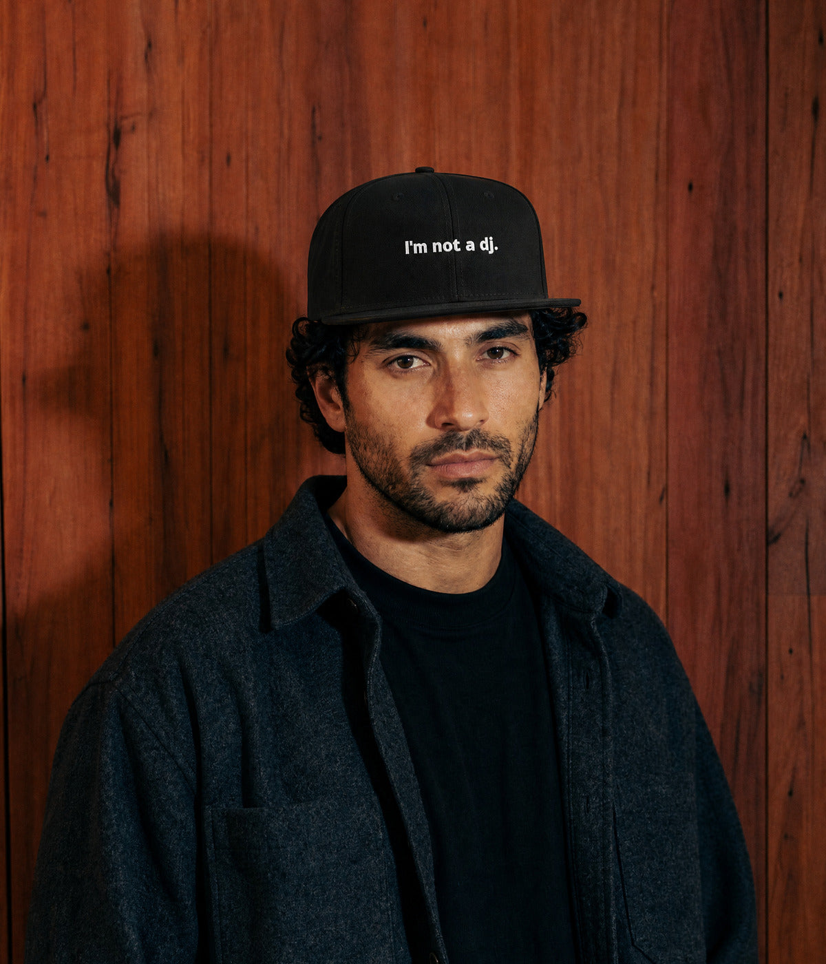 NOT A DJ SNAPBACK. BLACK worn by a man