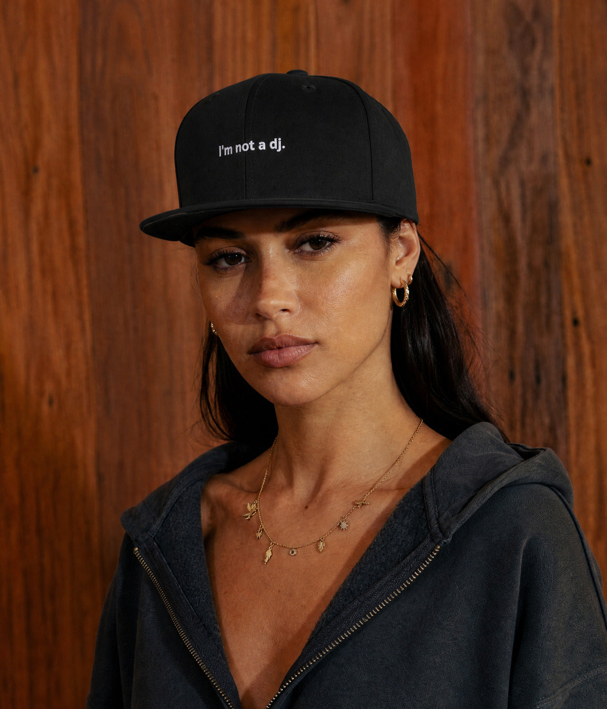 NOT A DJ SNAPBACK. BLACK worn by a woman