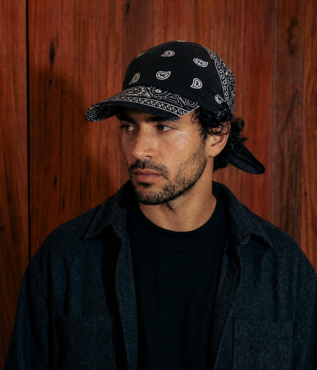 PEAKED BANDANA CAP. BLACK worn by a man