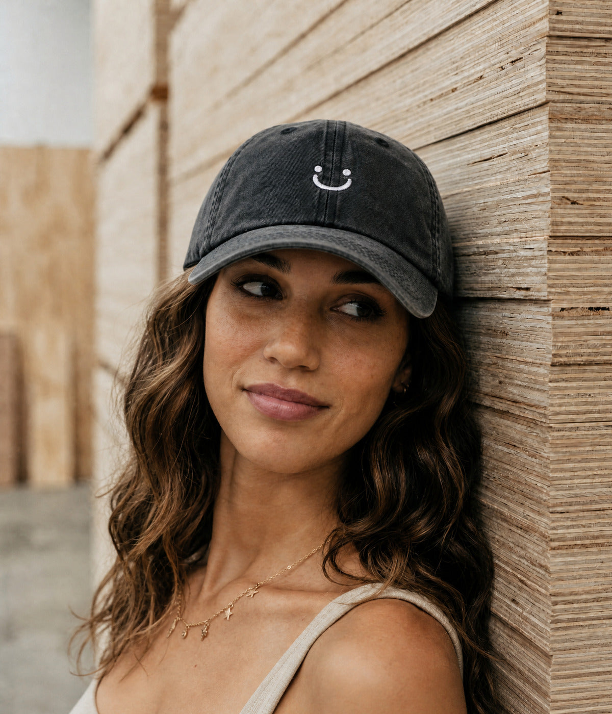 WASHED SMILEY FACE. BLACK worn by a woman