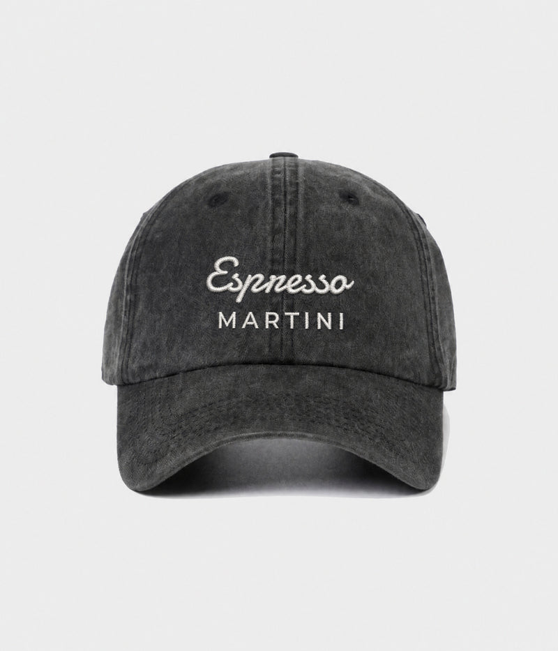 ESPRESSO MARTINI. washed black cotton dad cap with embroidered Espresso Martini wordmark, front view