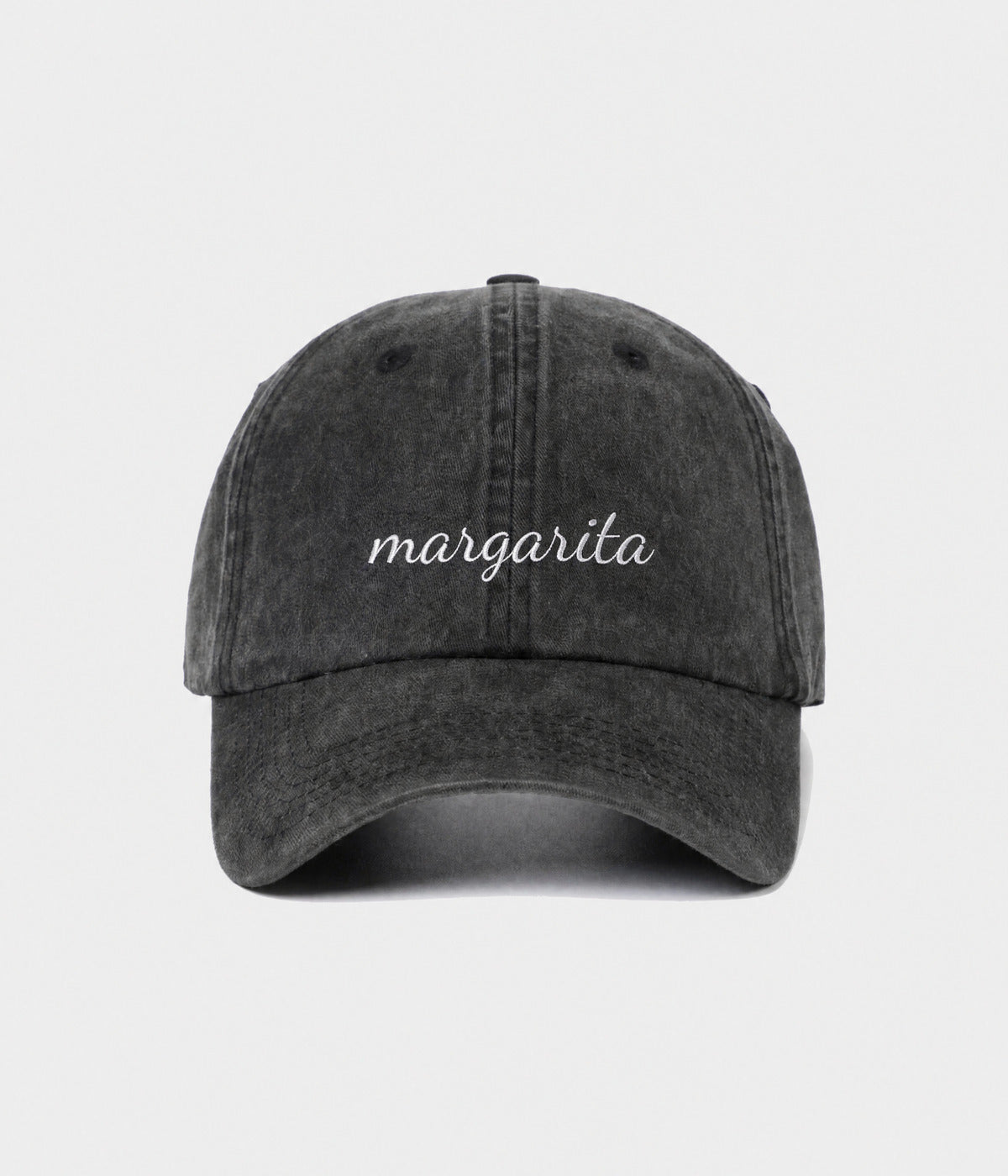 MARGARITA - CURSIVE. washed black cotton dad cap with embroidered margarita script, front view