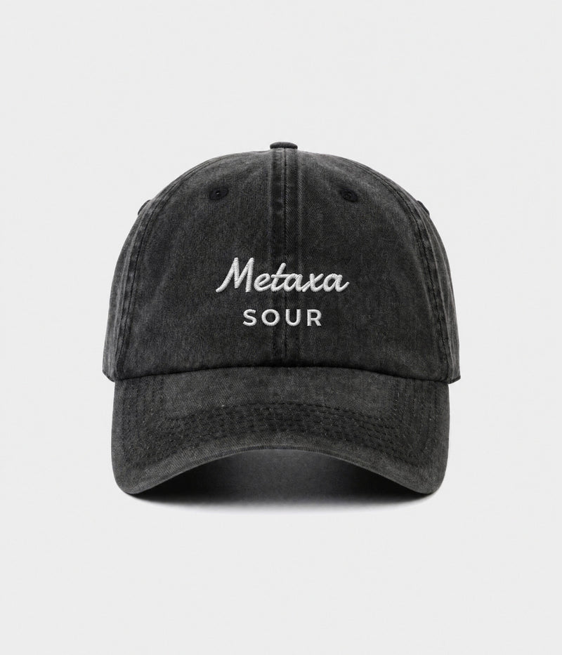 METAXA SOUR. washed black cotton dad cap with embroidered Metaxa Sour wordmark, front view