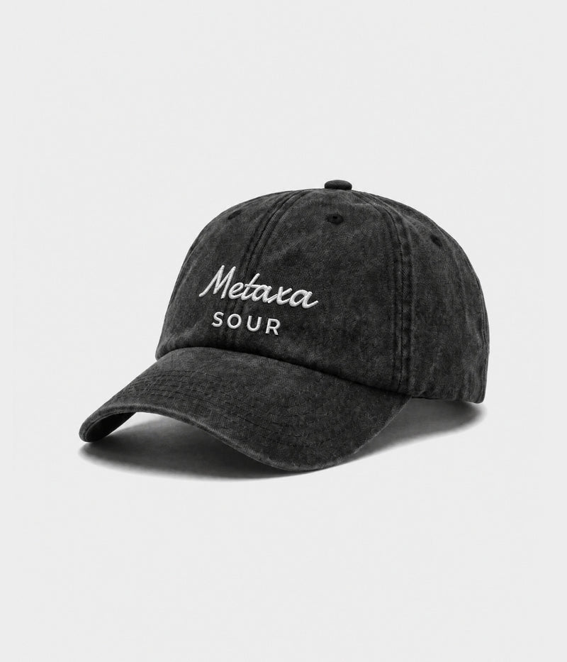 METAXA SOUR. washed black cotton dad cap with embroidered Metaxa Sour wordmark, side view