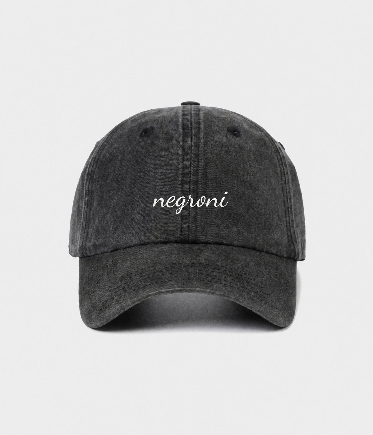 NEGRONI - CURSIVE. washed black cotton dad cap with embroidered negroni script, front view