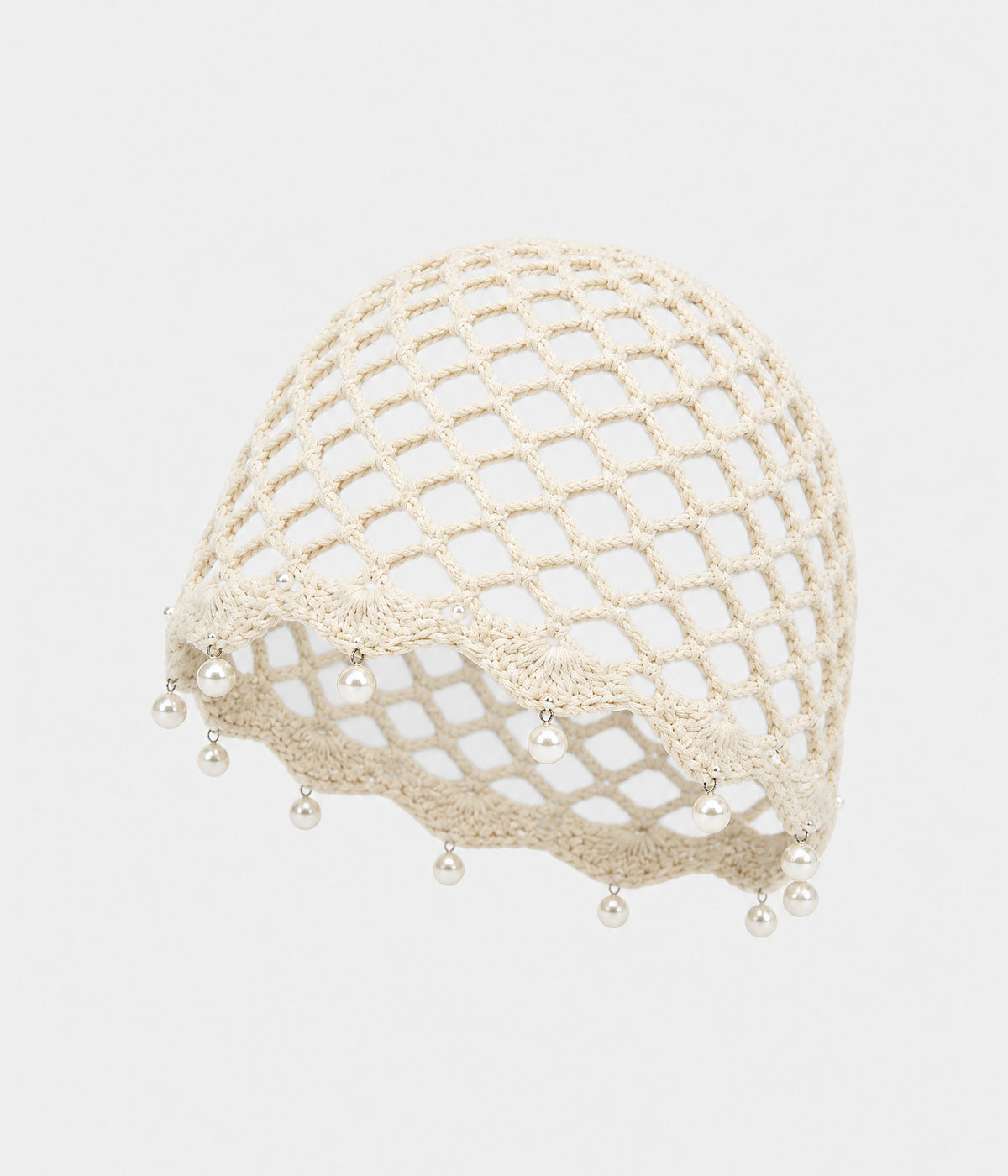 PEARL CROCHET CAP. open-mesh crochet cloche with pearl trim in beige, front view