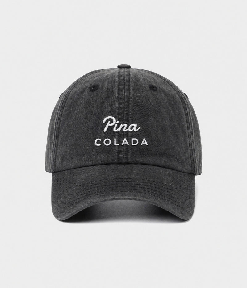 PINA COLADA. washed black cotton dad cap with embroidered Pina Colada wordmark, front view