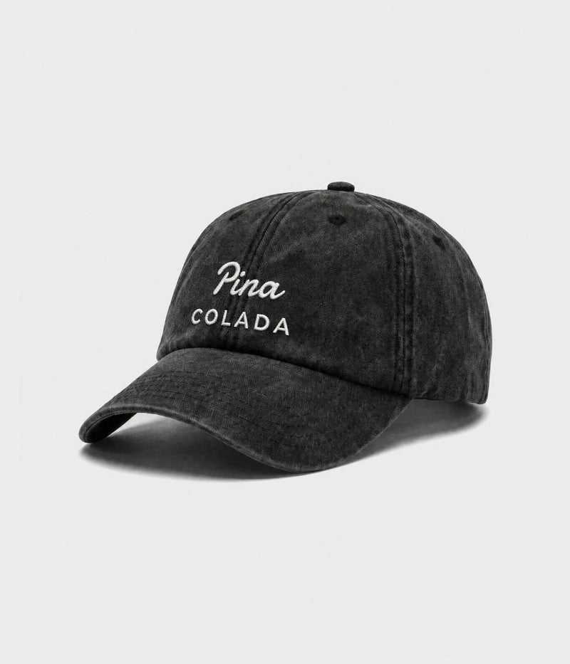 PINA COLADA. washed black cotton dad cap with embroidered Pina Colada wordmark, side view