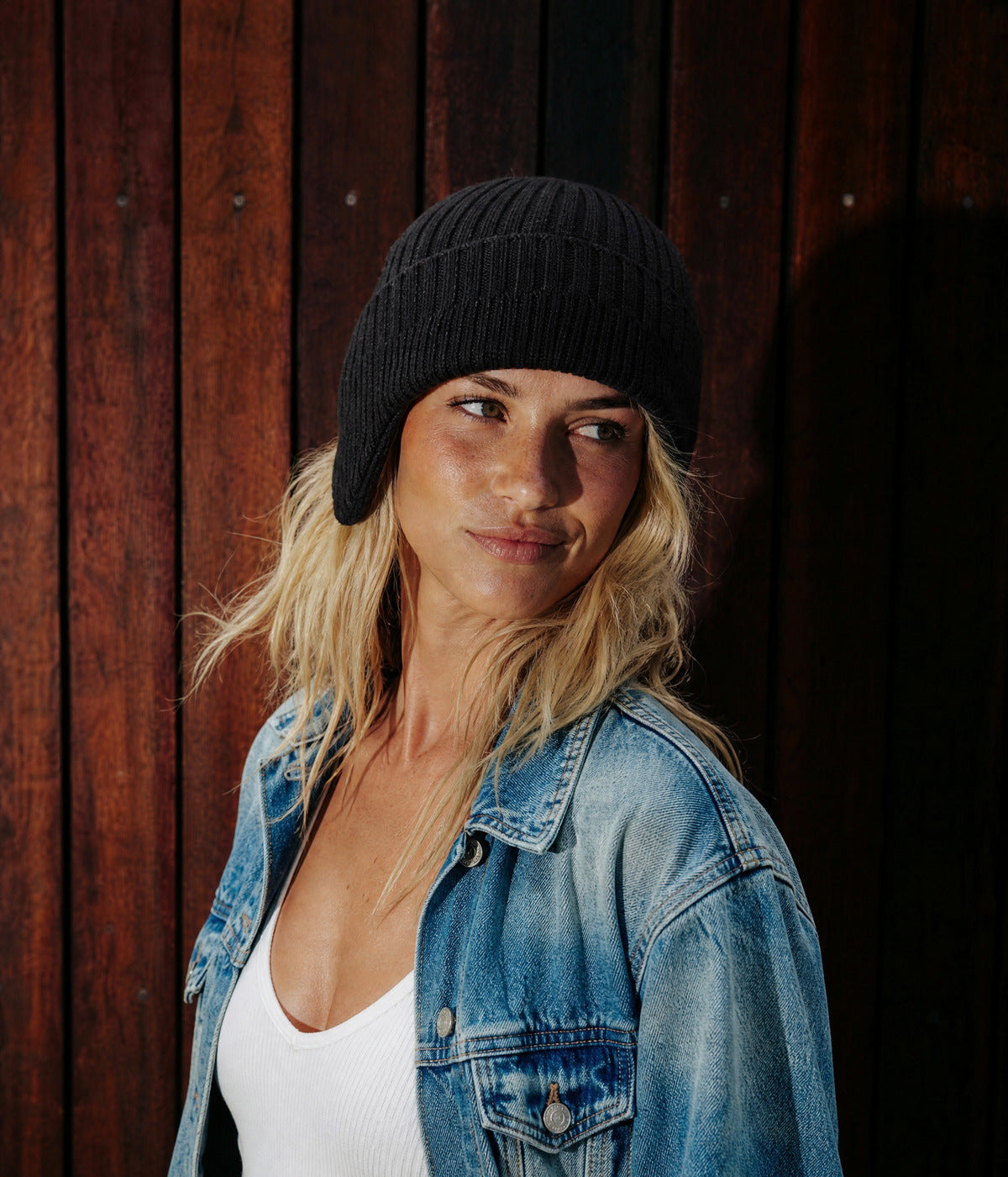 CABLE EARMUFF BEANIE. — BLACK worn