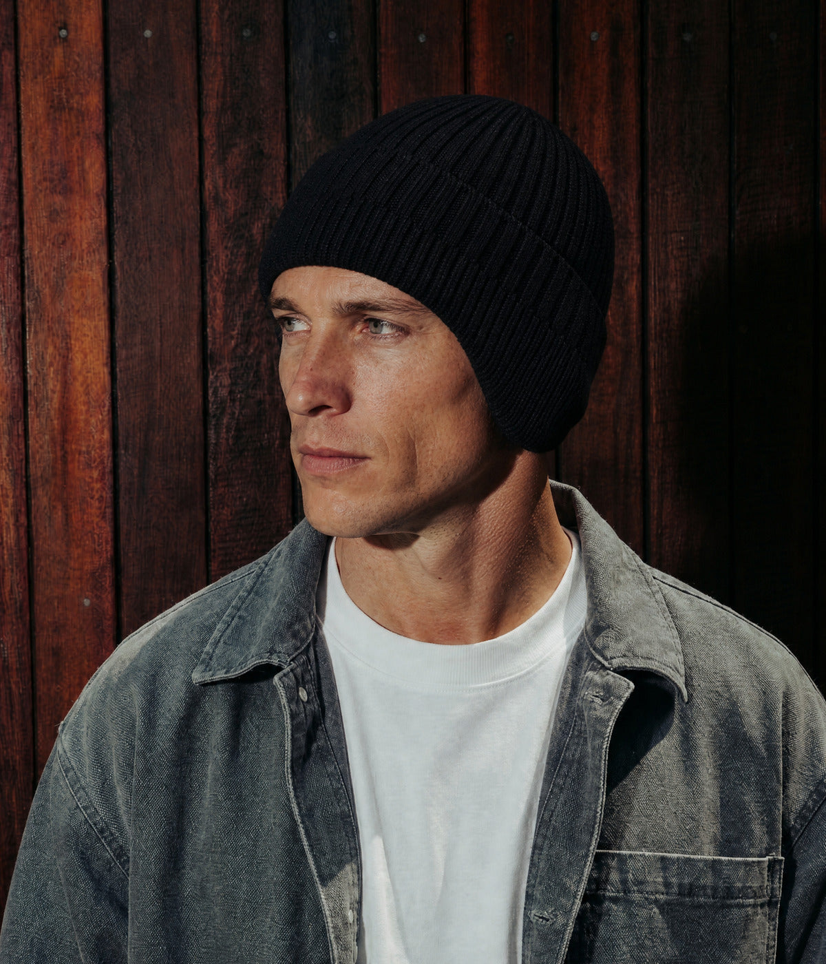 CABLE EARMUFF BEANIE. — BLACK worn