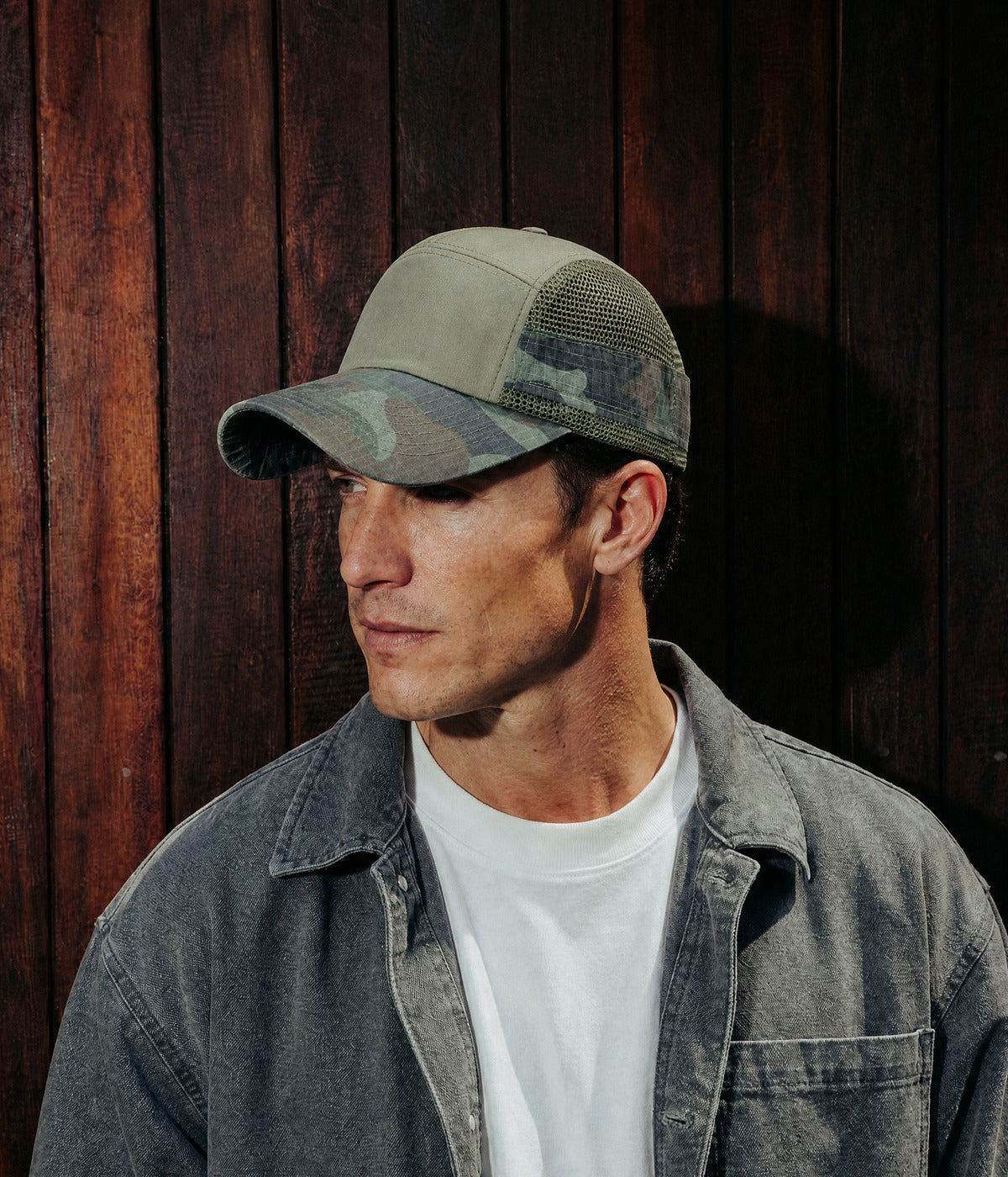 CAMO MESH CAP. ARMY GREEN worn by a man