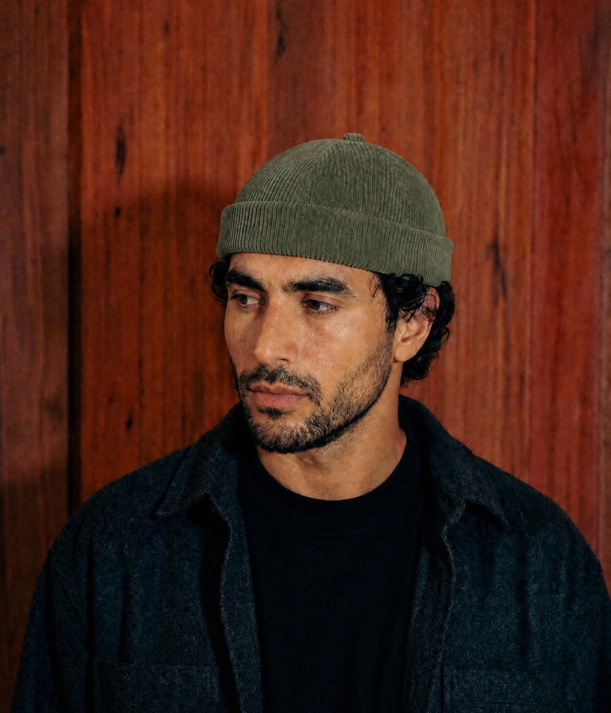 CORDUROY FISHERMAN BEANIE. — GREEN worn