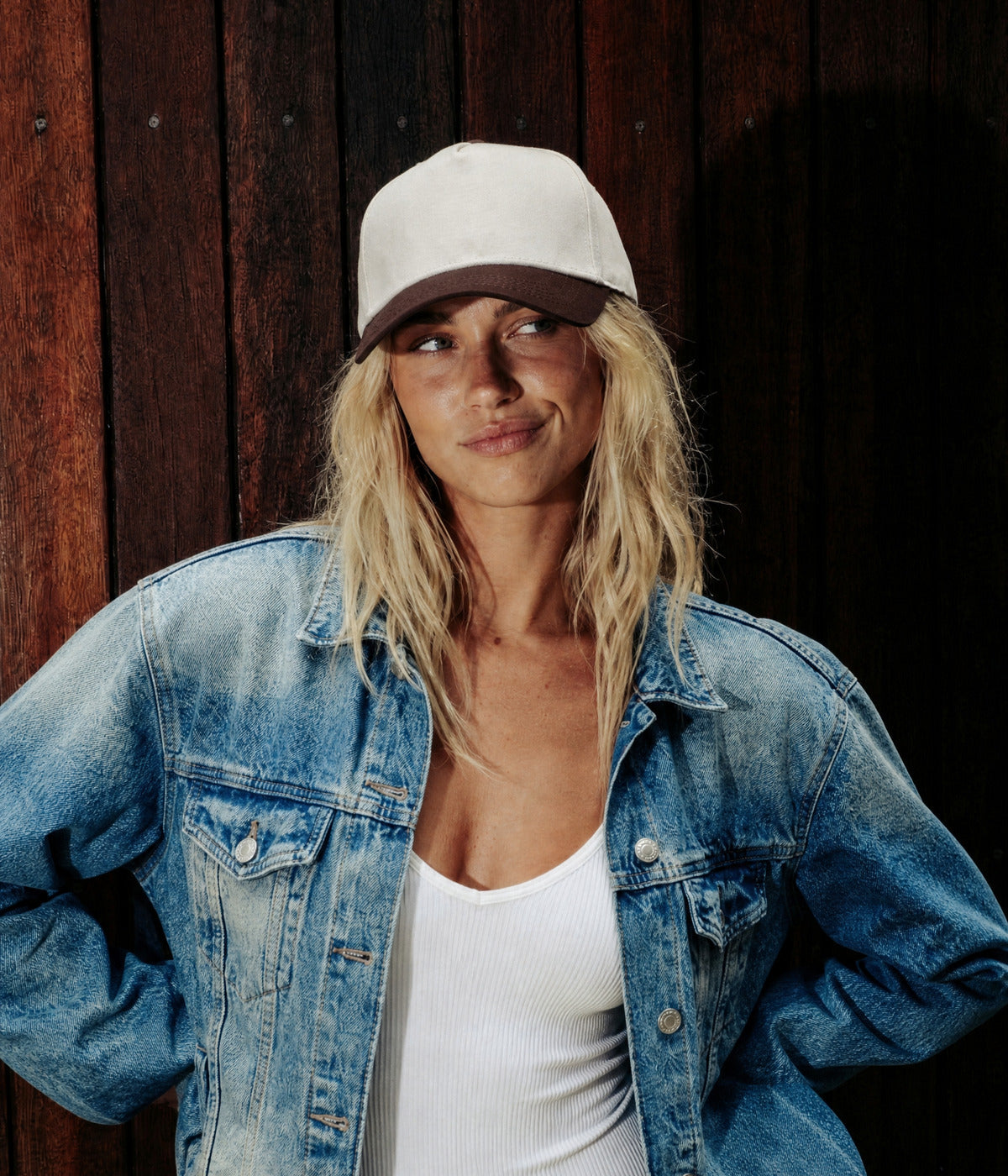 CORE 5-PANEL CAP. BROWN worn by a woman