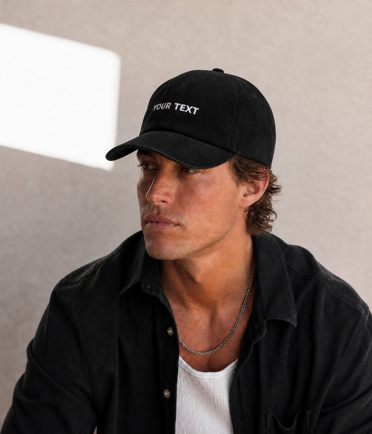 CUSTOM CORDUROY CAP. BLACK worn by a man