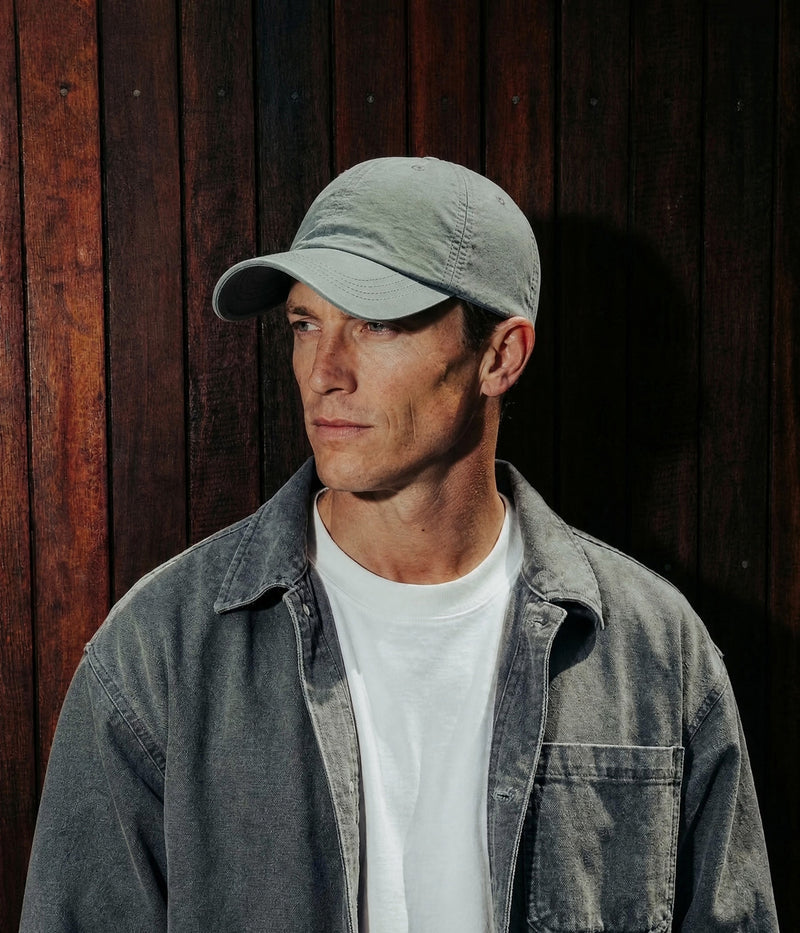DASH CAP. ARMY GREEN worn by a man