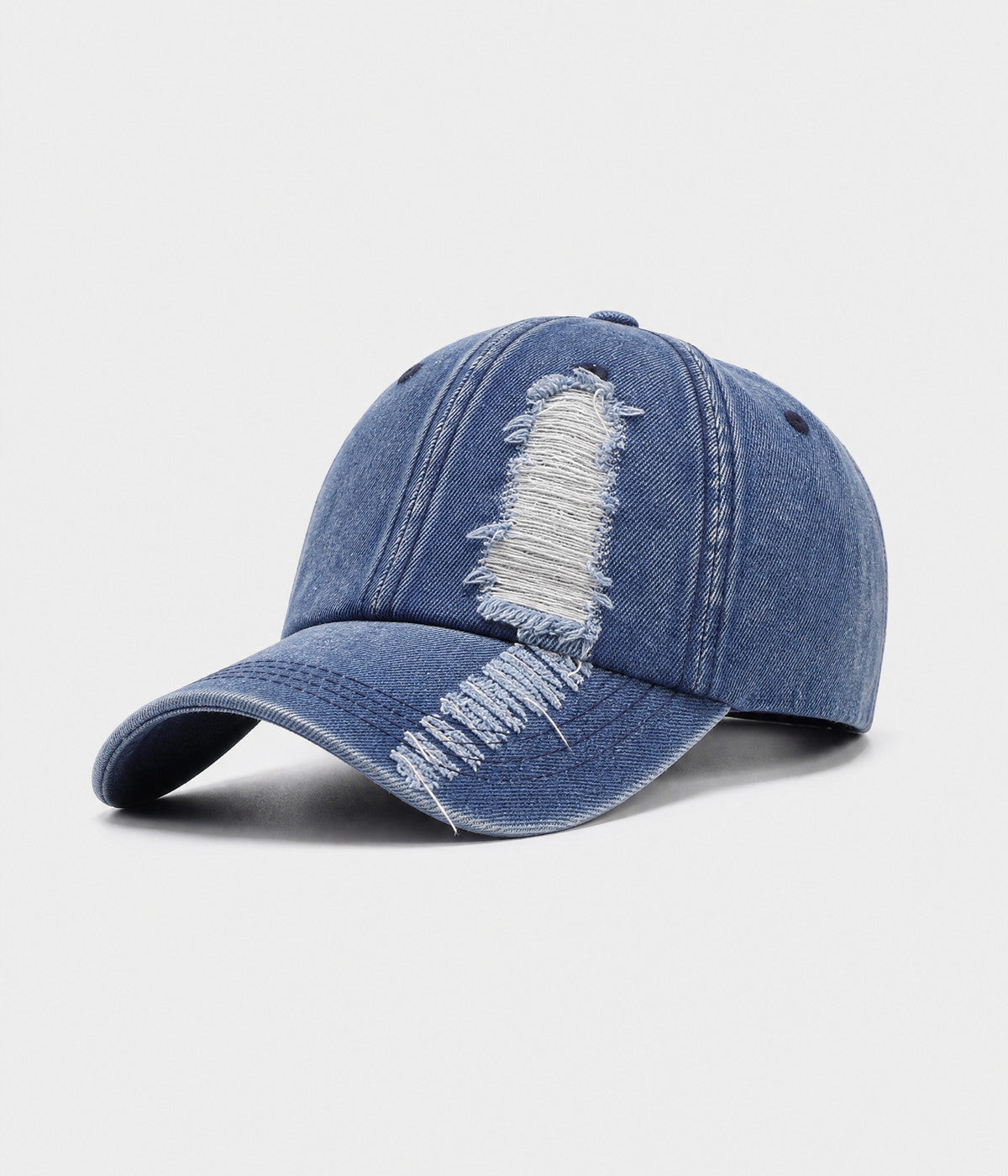 TORN DENIM. washed cotton denim cap in blue, side view