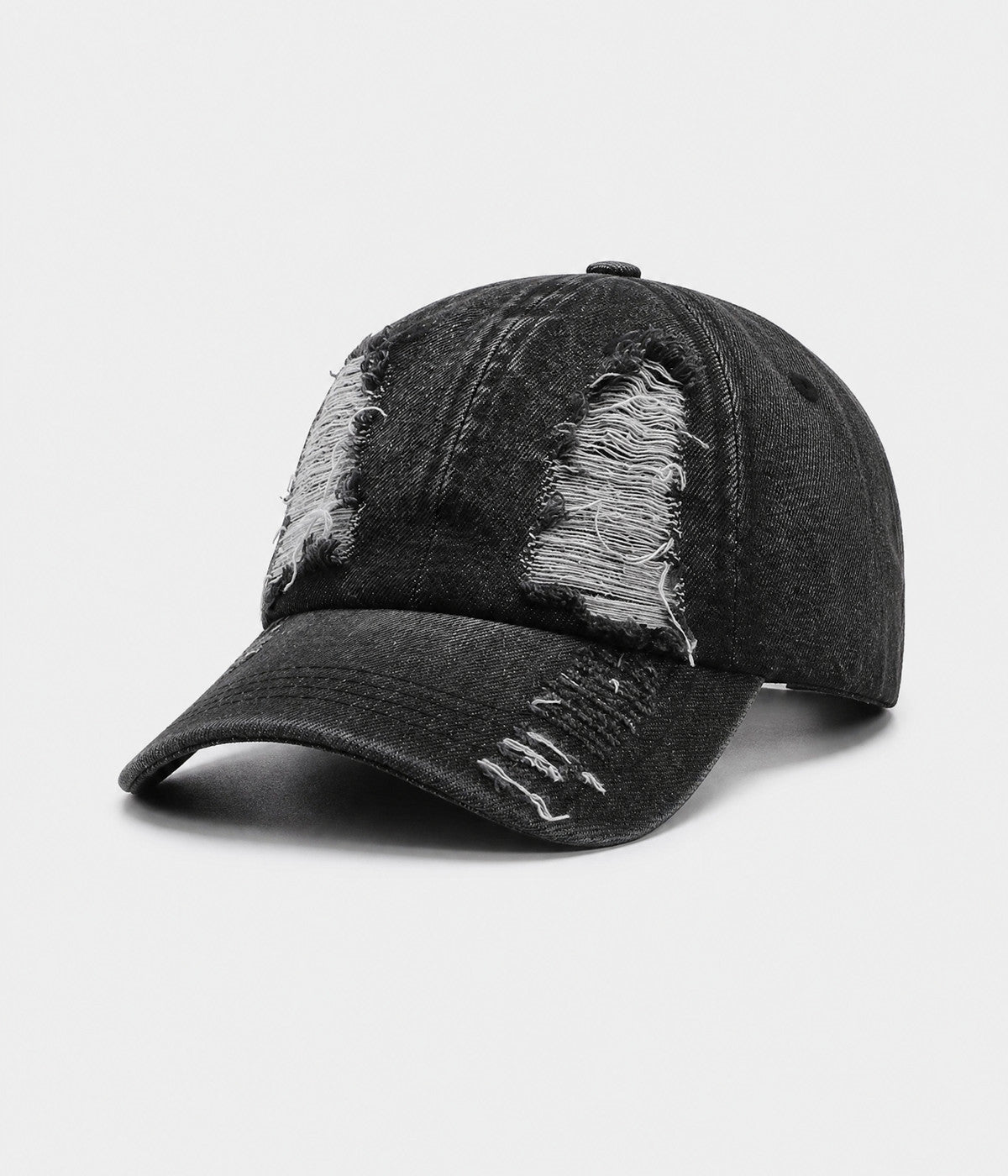 TORN DENIM. washed cotton denim cap in black, side view