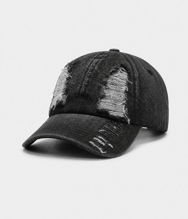 TORN DENIM. washed cotton denim cap in black, side view