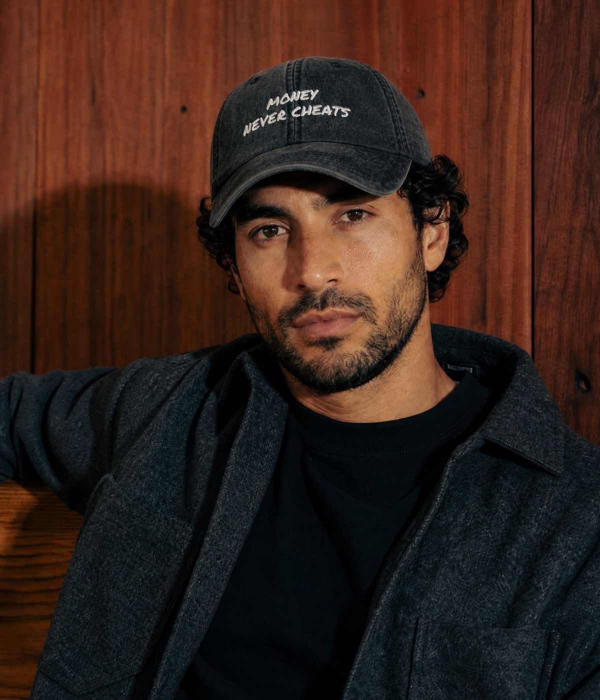 MONEY NEVER CHEATS CAP — Black worn