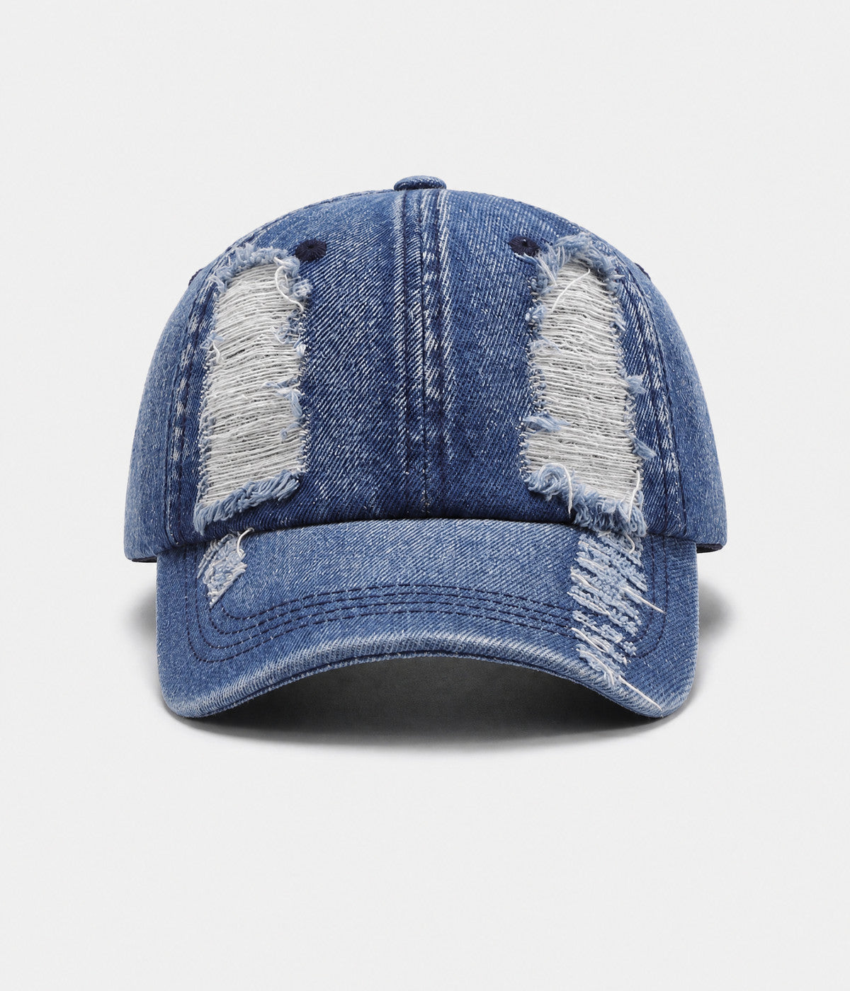 TORN DENIM. washed cotton denim cap in blue, front view