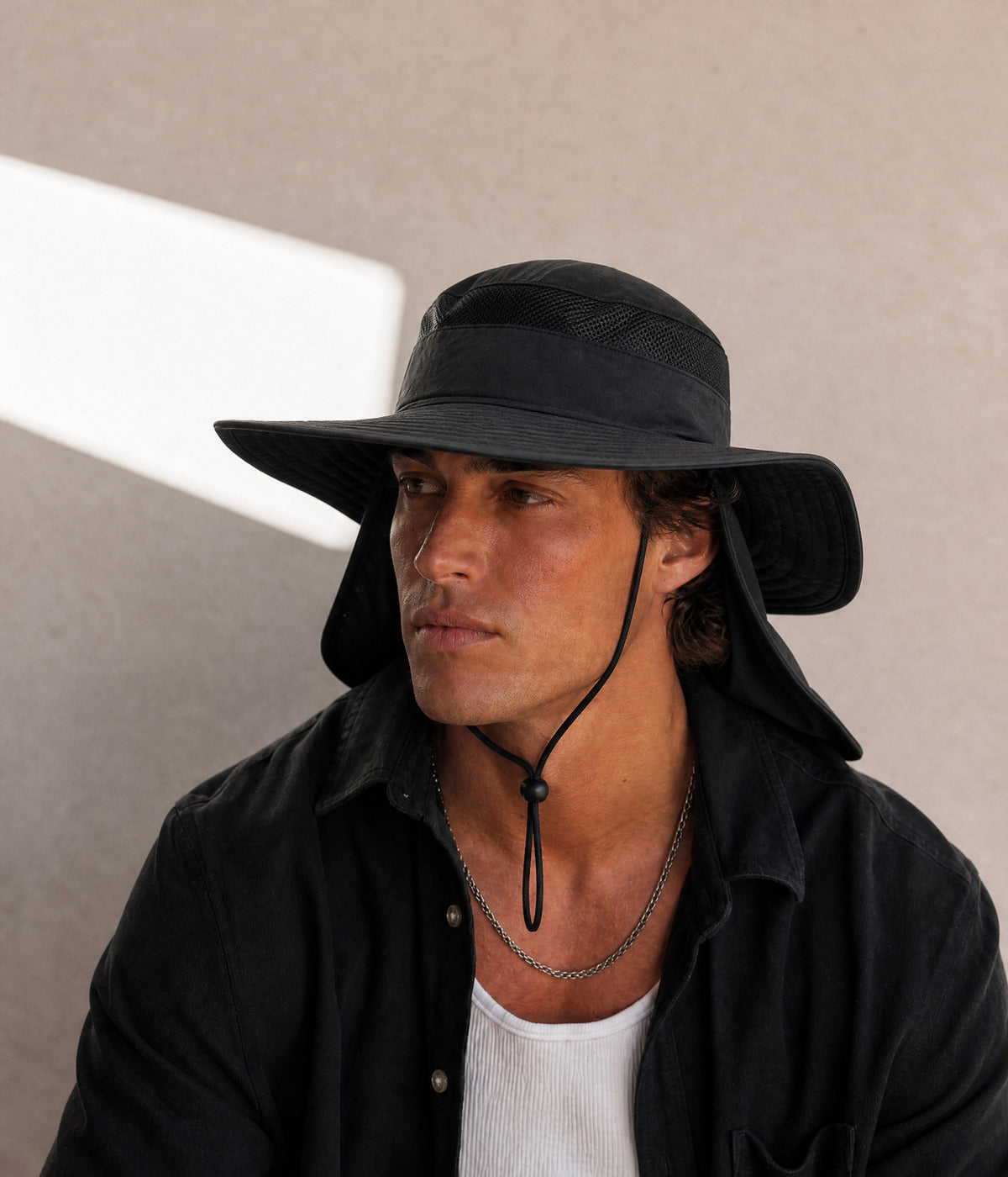 FISHER HAT. BLACK worn by a man