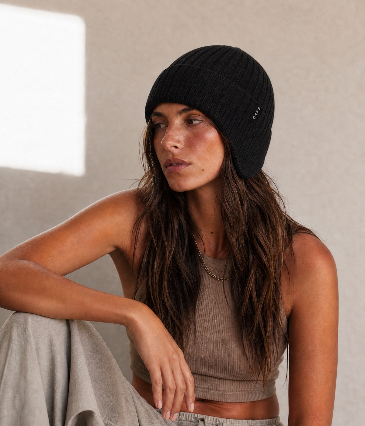 LOGO CABLE EARMUFF BEANIE. — BLACK worn