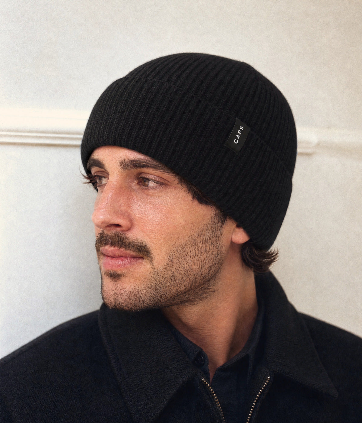LOGO MERINO BEANIE. — BLACK worn