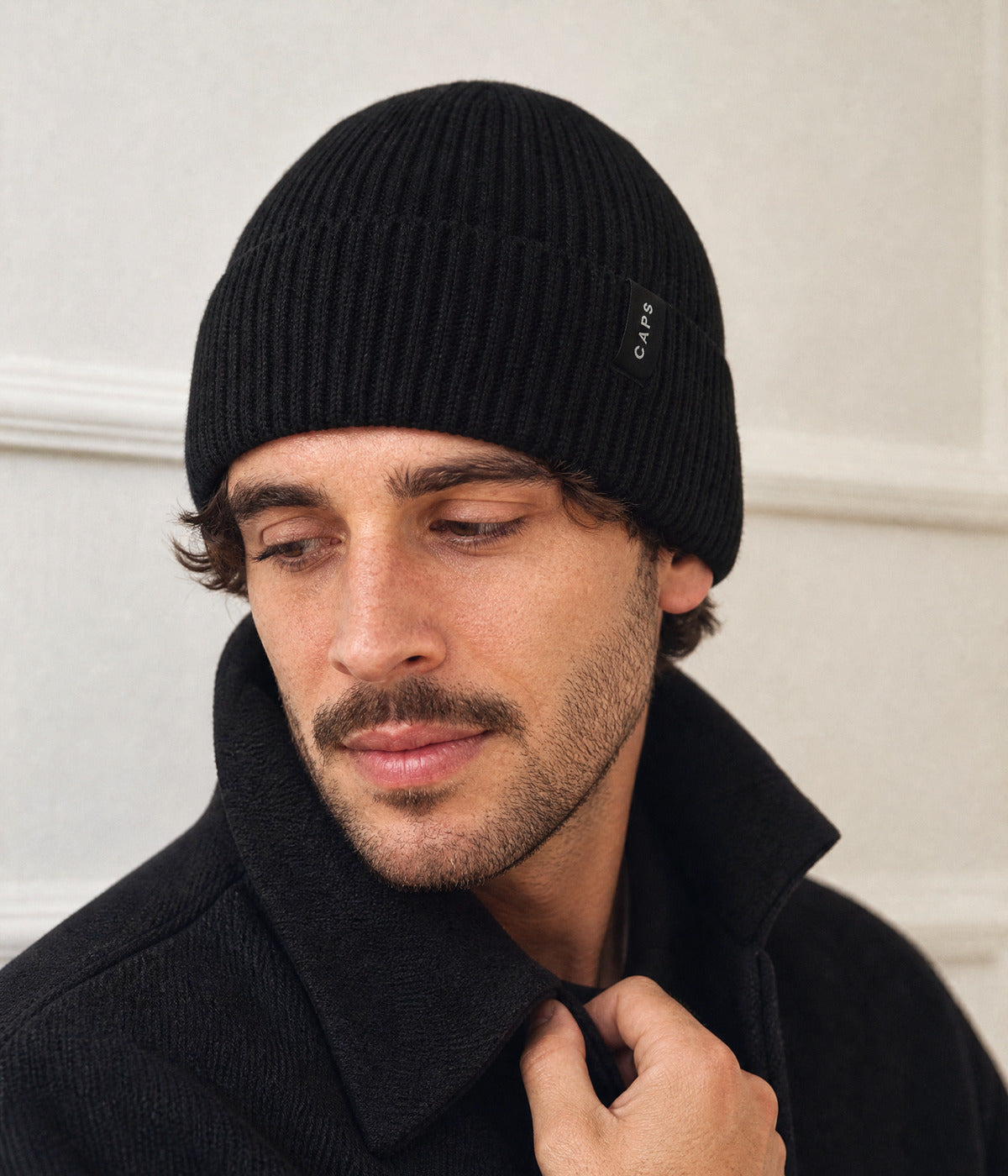LOGO MERINO BEANIE. — BLACK worn