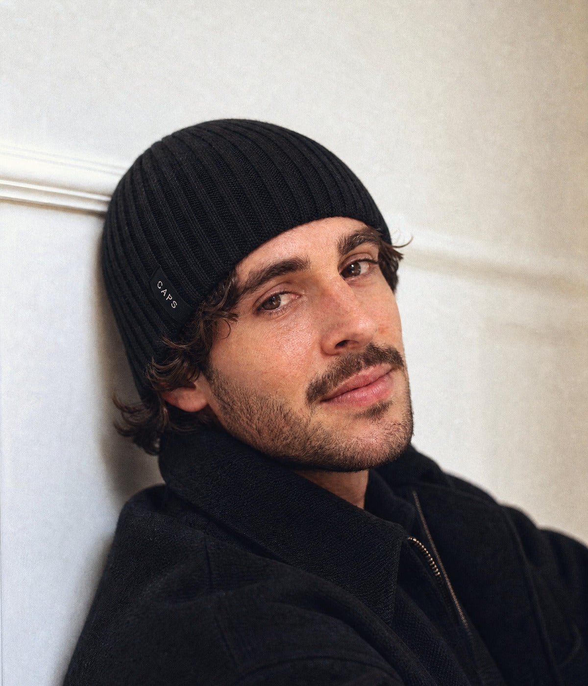 LOGO RIB KNIT BEANIE. — BLACK worn