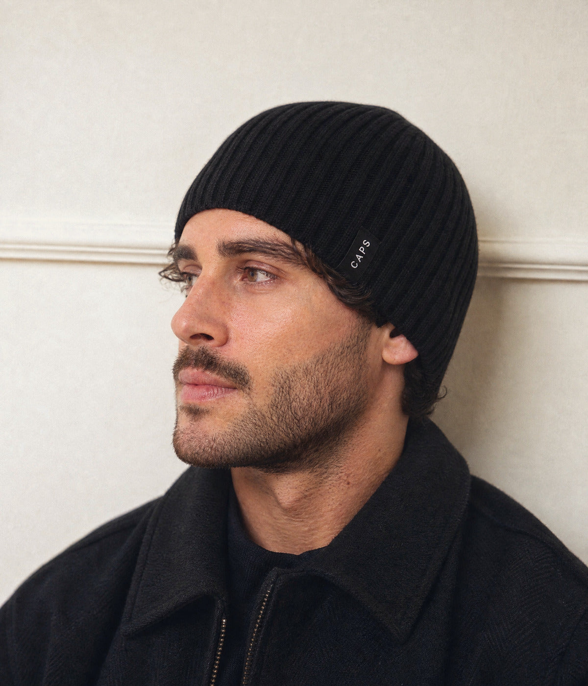 LOGO RIB KNIT BEANIE. — BLACK worn