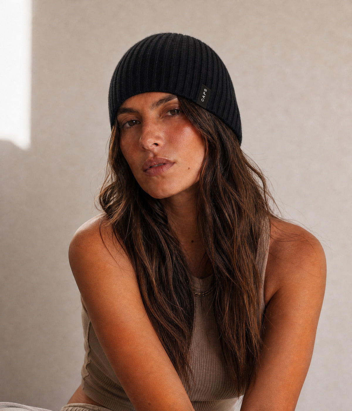 LOGO RIB KNIT BEANIE. — BLACK worn