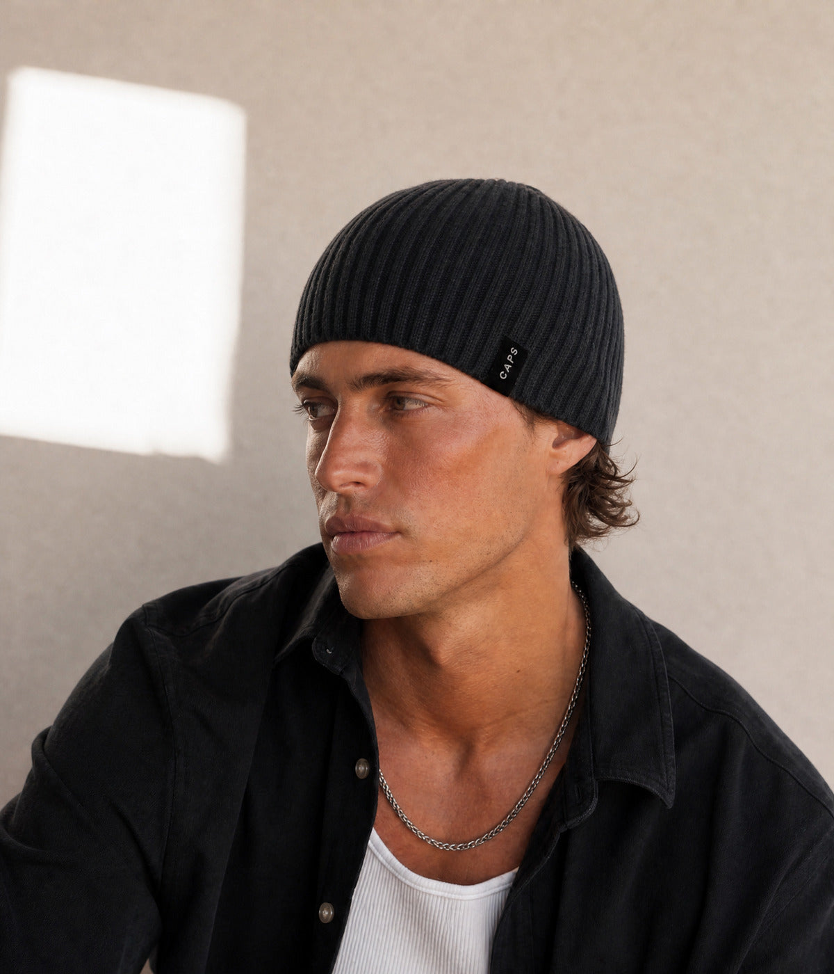 LOGO RIB KNIT BEANIE. — BLACK worn