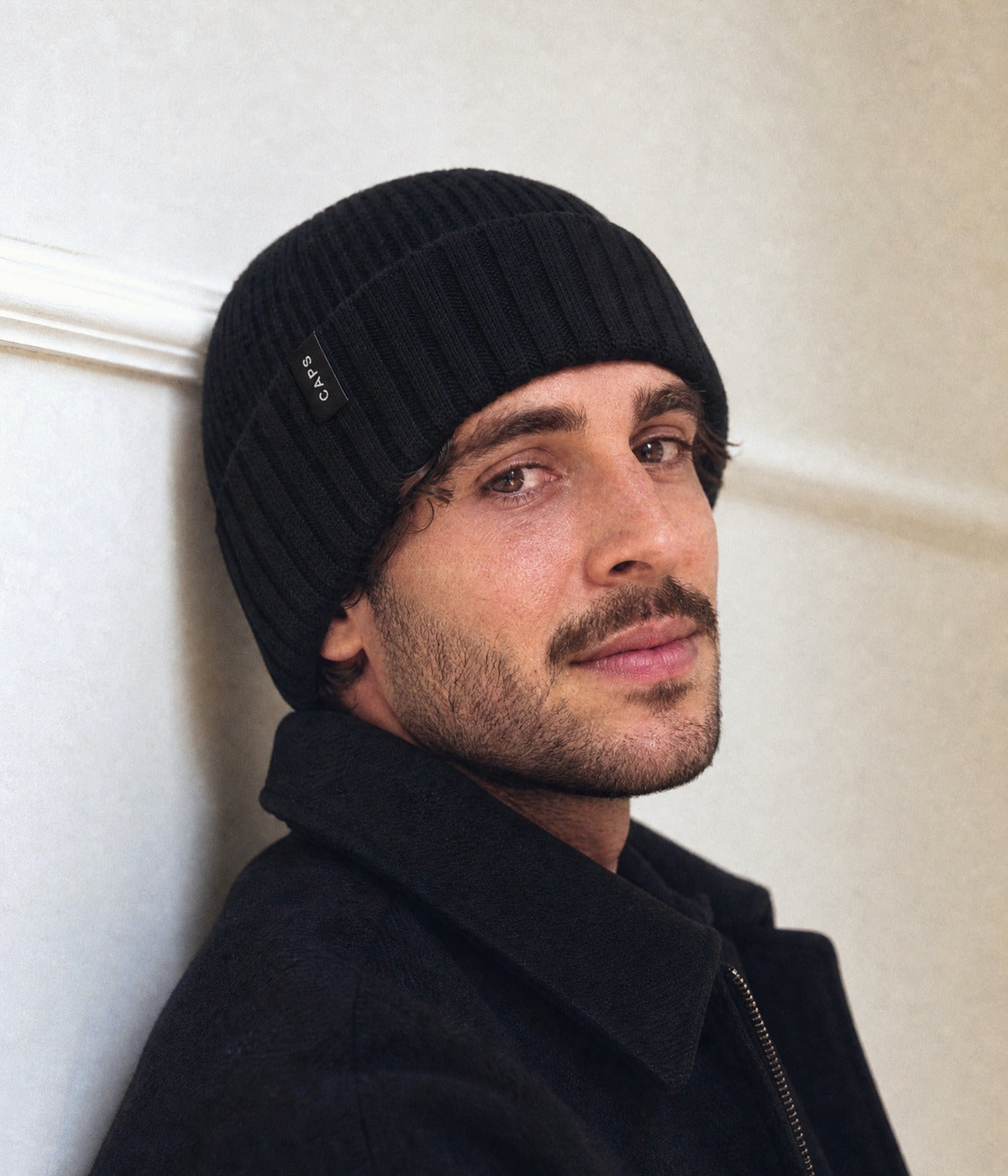 LOGO RIBBED BEANIE. — BLACK worn
