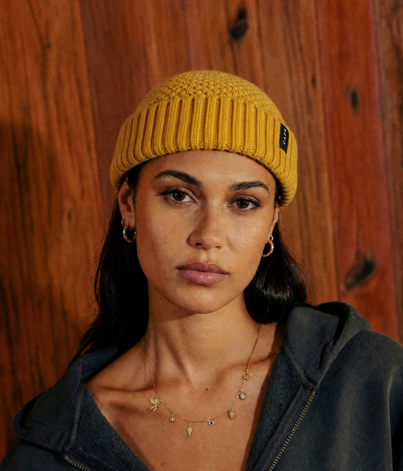 LOGO RIBBED FISHERMAN BEANIE. — MUSTARD YELLOW worn