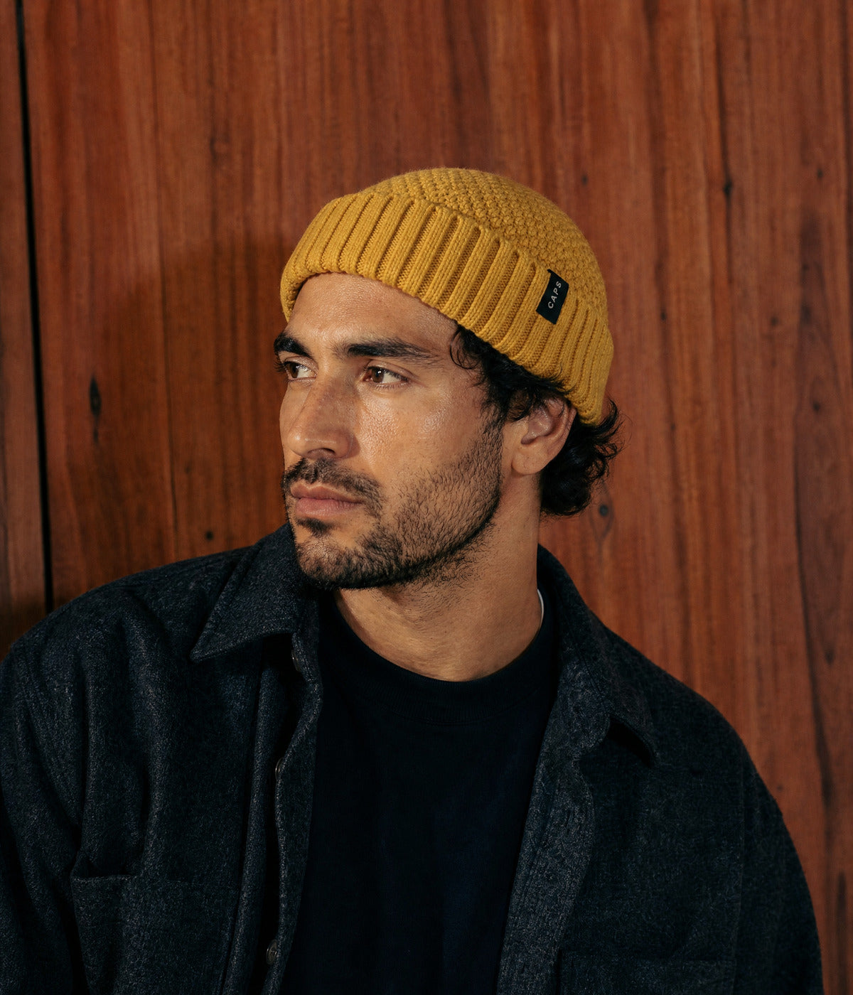 LOGO RIBBED FISHERMAN BEANIE. — MUSTARD YELLOW worn
