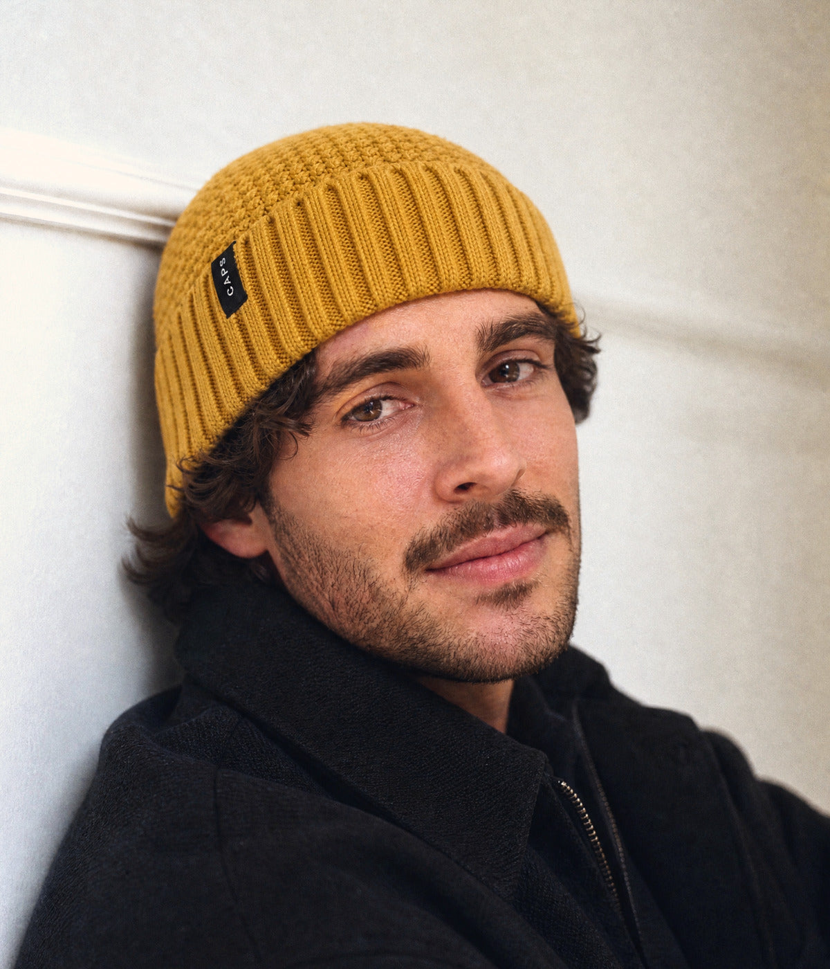 LOGO RIBBED FISHERMAN BEANIE. — MUSTARD YELLOW worn