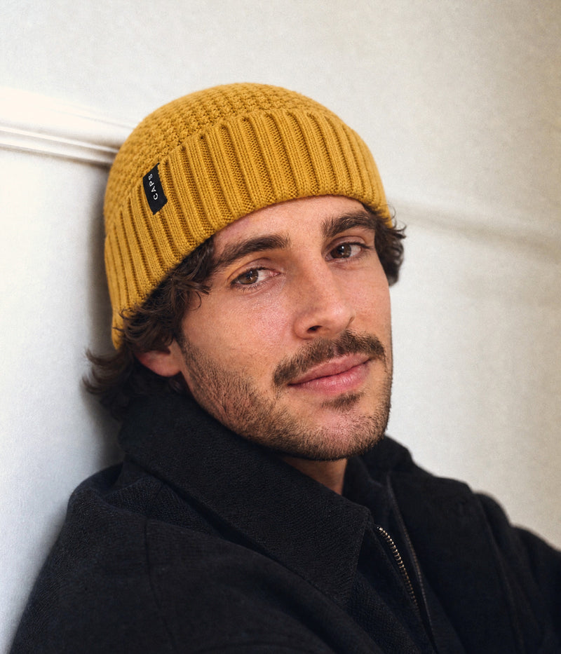 LOGO RIBBED FISHERMAN BEANIE. — MUSTARD YELLOW worn